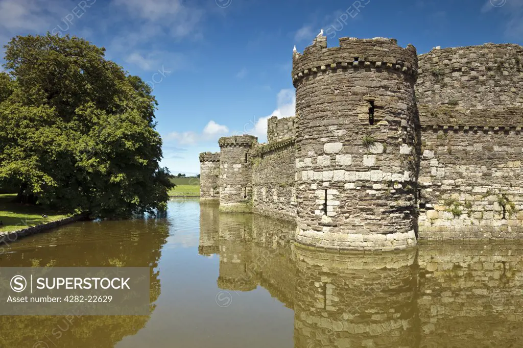 Wales, Anglesey, Beaumaris. The outer curtain wall and moat of Beaumaris Castle, the last and largest of the castles to be built by King Edward I in Wales.