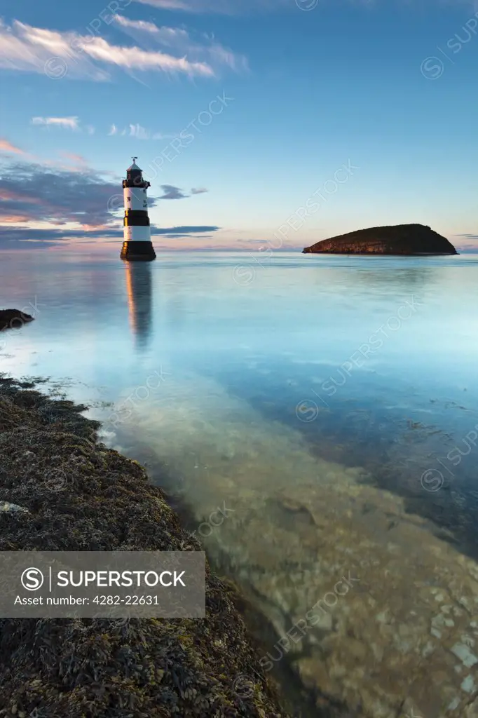 Wales, Anglesey, Penmon. Penmon lighthouse and Puffin Island at Penmon Point on the Isle of Anglesey.
