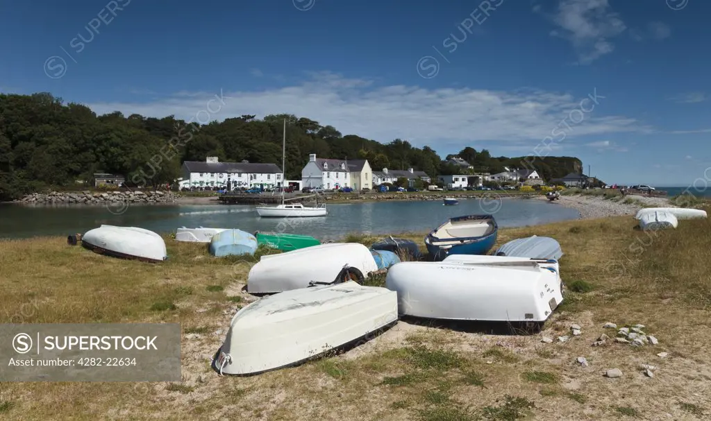 Wales, Anglesey, Red Wharf Bay. Upturned rowing boats opposite the Ship Inn at Red Wharf Bay on the Isle of Anglesey in Wales.