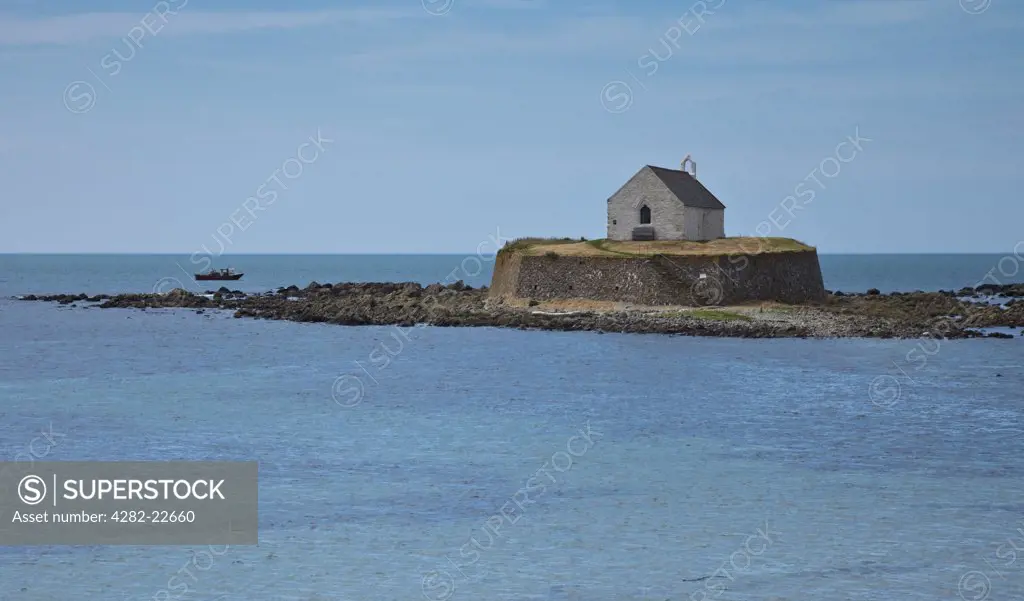 Wales, Anglesey, near Aberffraw. St Cwyfan's Church, known as the Church in the Sea, on a small tidal island called Cribinau off the coast of Anglesey.