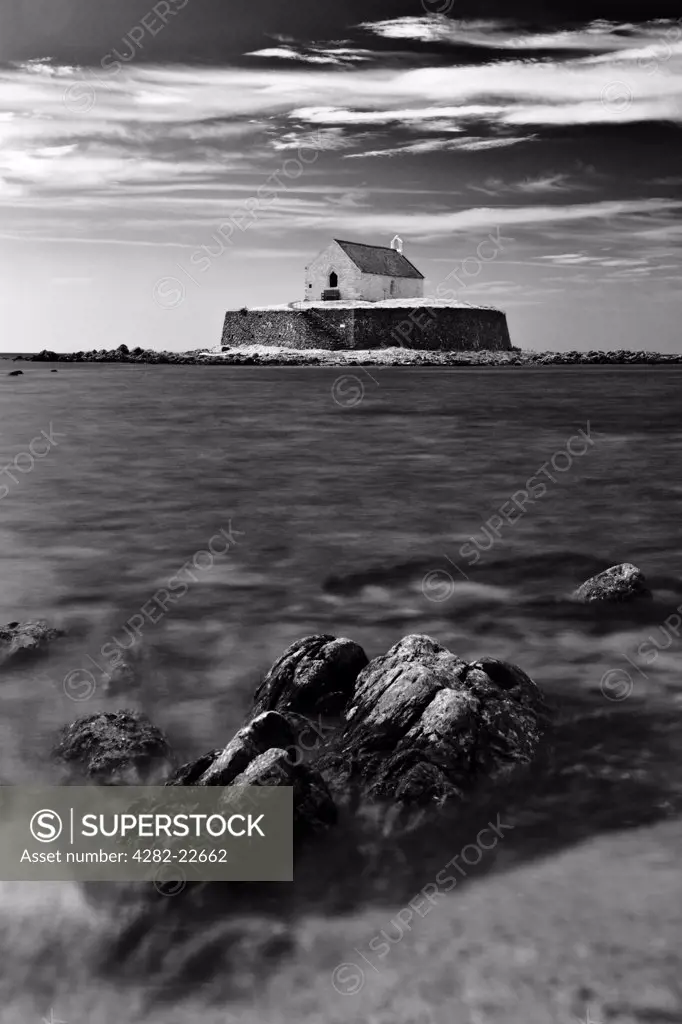 Wales, Anglesey, near Aberffraw. St Cwyfan's Church, known as the Church in the Sea, on a small tidal island called Cribinau off the coast of Anglesey.