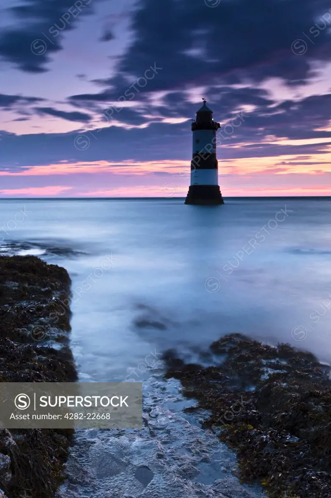 Wales, Anglesey, Penmon. Penmon lighthouse at Penmon Point on the Isle of Anglesey at dawn.