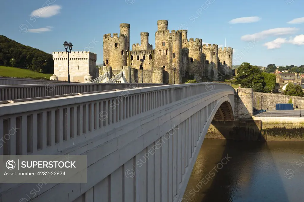 Wales, Conwy, Conwy. Conwy Castle, built for King Edward I between 1283-87 by Master James of St George, viewed from the modern road bridge that runs alongside Thomas Telford's suspension Bridge that was completed in 1826.