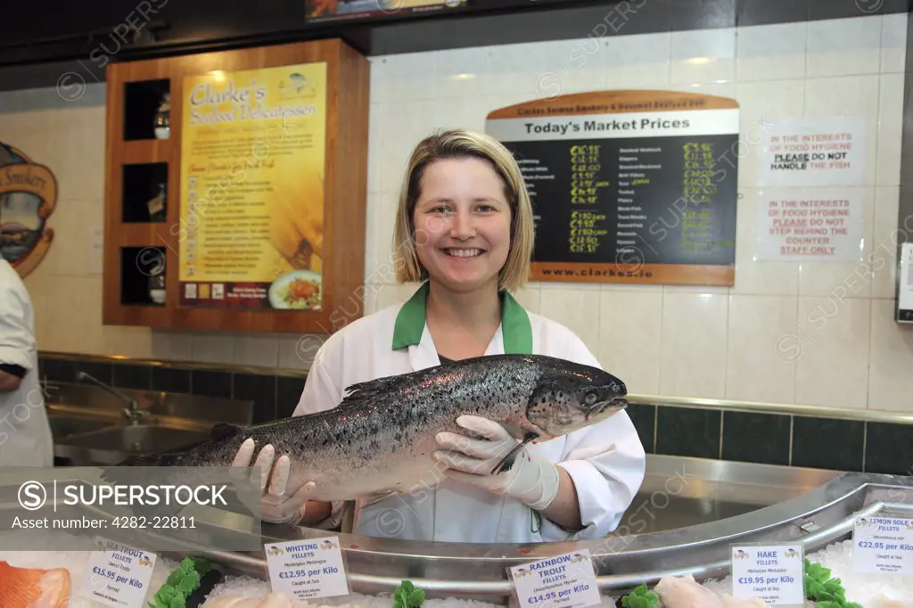 Republic of Ireland, County Mayo, Ballina. A wild Salmon held by a shop assistant in Clarke's Seafood Delicatessen. Clarke's has supplied salmon to the Vatican.