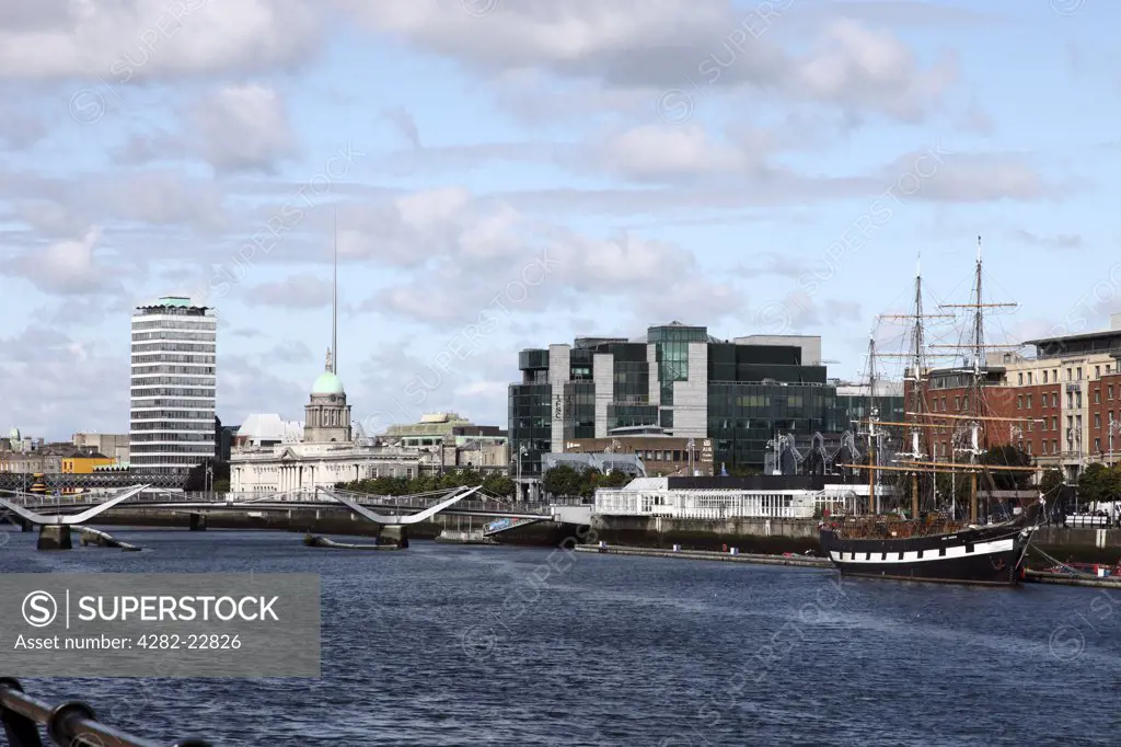 Republic of Ireland, Dublin City, Dublin. View along the River Liffey towards Custom House Quay from the South Quays featuring Liberty Hall, Customs House, the chq Building, AIB Trade Centre, Sean O'Casey Bridge and the replica Famine Ship Jeanie Johnston.