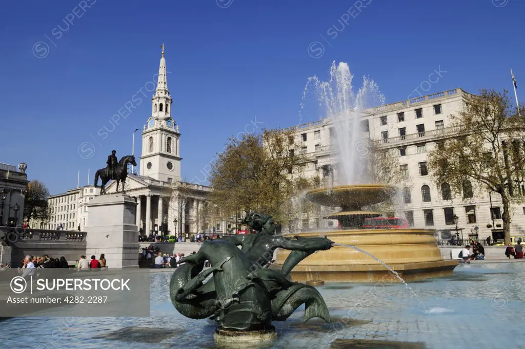England, London, Trafalgar Square. Fountain in Trafalgar Square, with Church of St Martin-in-the-Fields in the background.