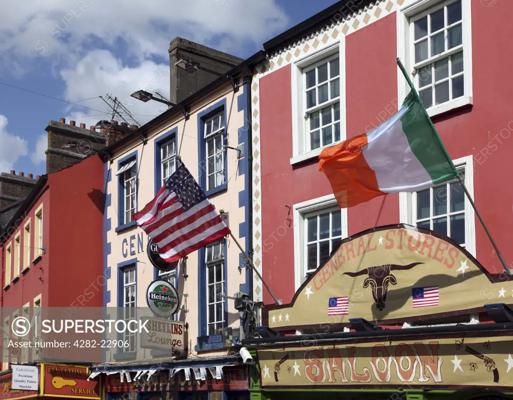 Republic of Ireland, County Monaghan, Carrickmacross. US and Irish flags flying ouside a General Stores in Main Street, Carrickmacross.