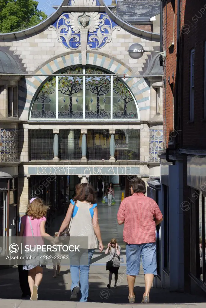 England, Norfolk, Norwich. A family entering the Royal Arcade, built in 1899 on the site of the yard of the Royal Hotel.
