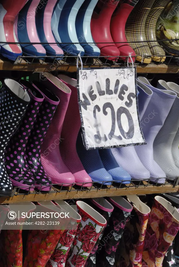 England, London, Camden Town. Colourful Wellington boots for sale from a market stall.