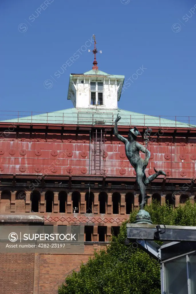 England, Essex, Colchester. A statue of Mercury on the Mercury Theatre in front of the Jumbo Water Tower (the largest Victorian water tower in England) at the Balkerne Gate in Colchester.