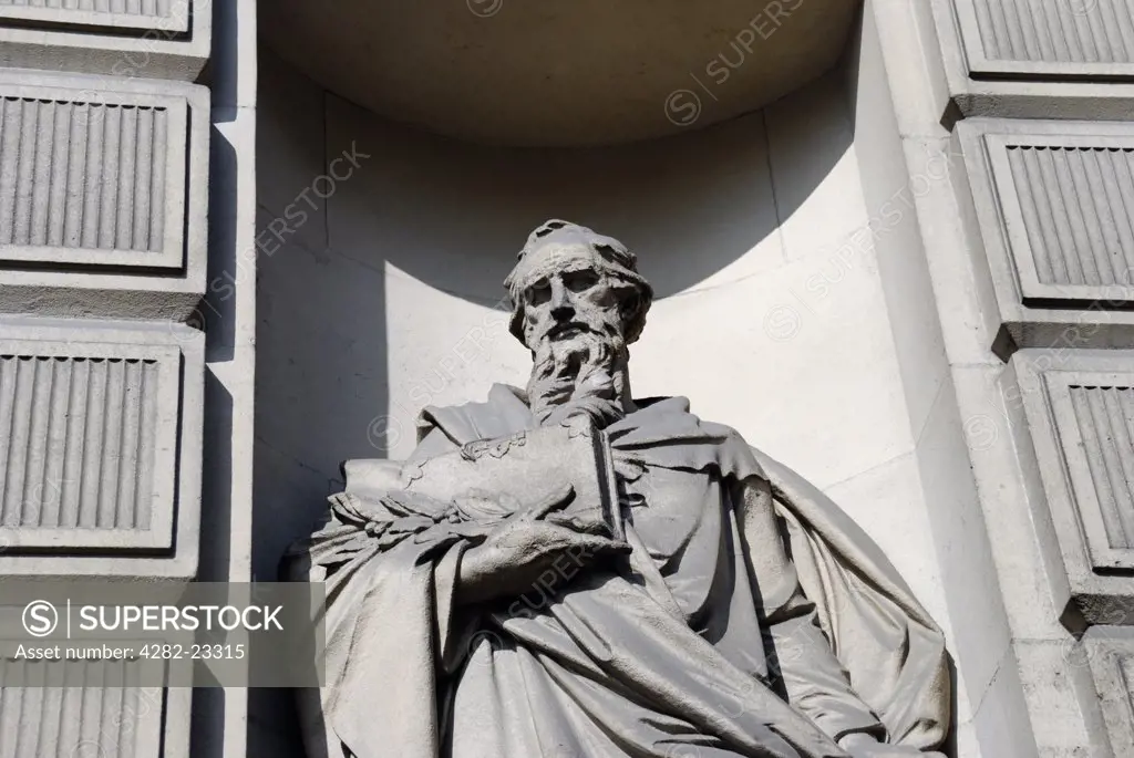England, London, City of London. Statue of a banker on the exterior of the former Midland Bank headquarters building in Poultry.