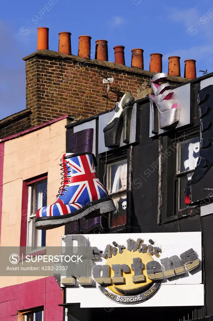 England, London, Camden. Large models of shoes hanging above a shoe shop in Camden High Street.