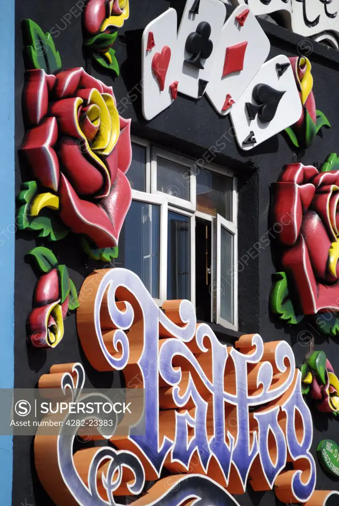 England, London, Camden. A colourful tattoo parlour shop front near Camden Market.