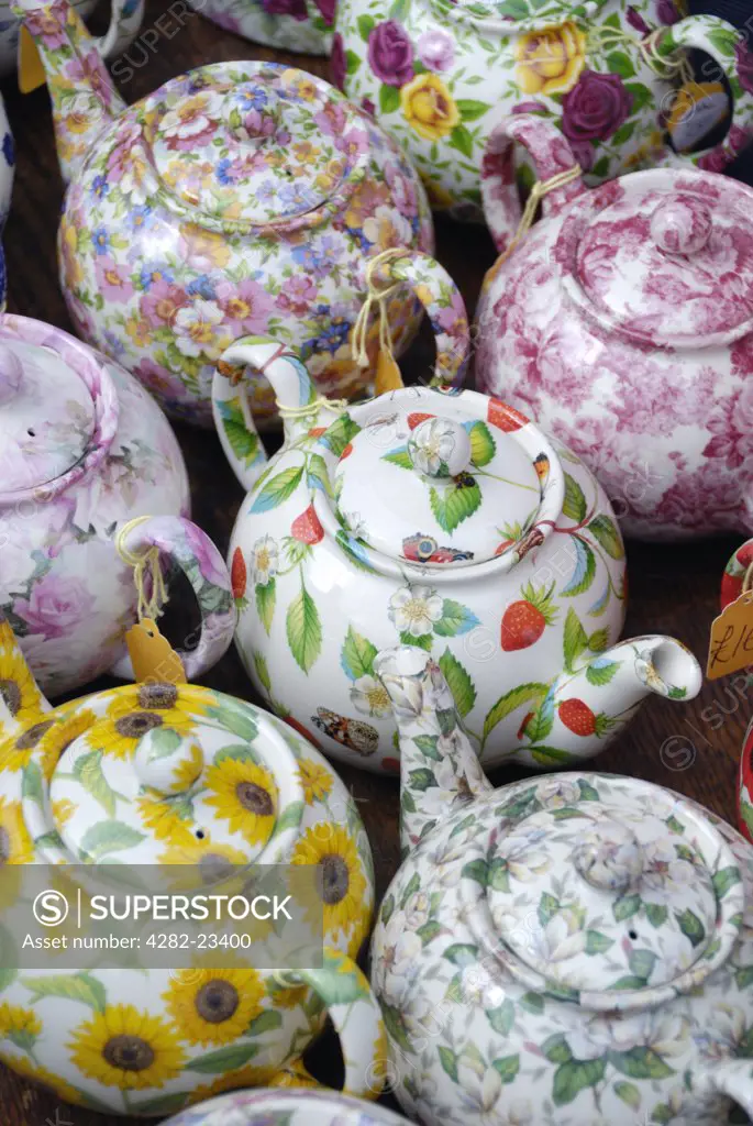 England, London, Portobello Road. Colourful English China teapots displayed on a market stall in Portobello Road.