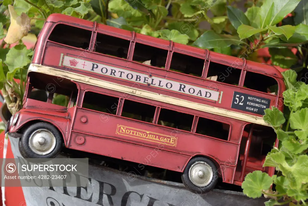 England, London, Portobello Road. Model replica of a red London routemaster double-decker bus in a Portobello Road antiques shop.