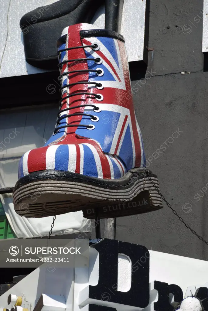 England, London, Camden. A giant Doctor Martin boot in Union Jack colours above a shop in Camden Town.
