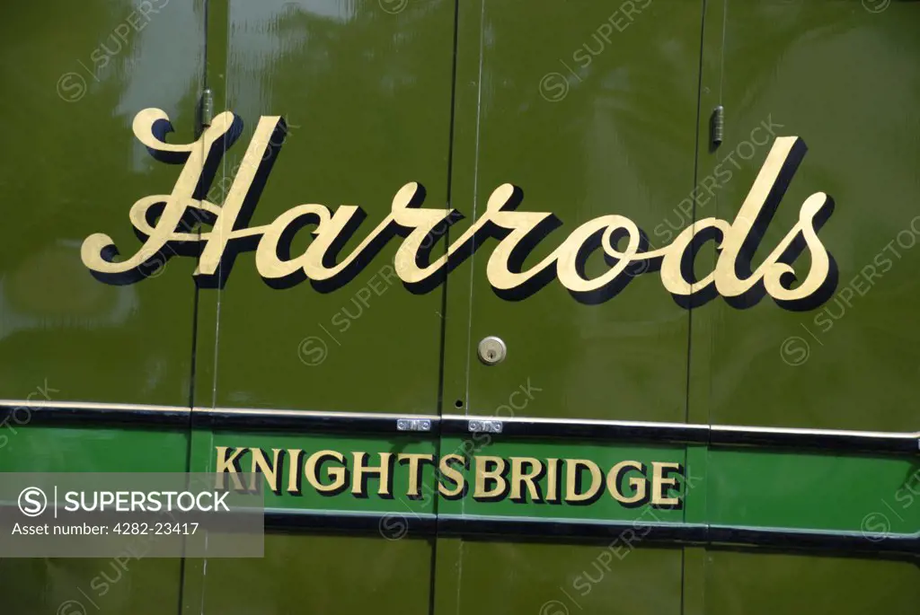 England, London, Westminster. A close up the Harrods logo on the side of a vintage delivery van.