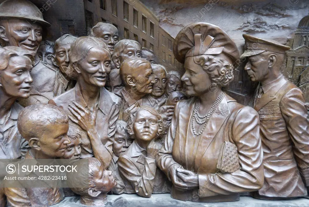 England, London, The Mall. Part of a bronze relief showing Queen Elizabeth the Queen Mother and King George VI meeting London citizens during the Blitz.