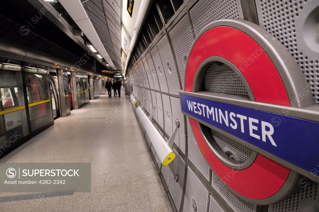 England, London, Westminster. A tube train alongside a platform on the Jubilee line at Westminster Underground Station.