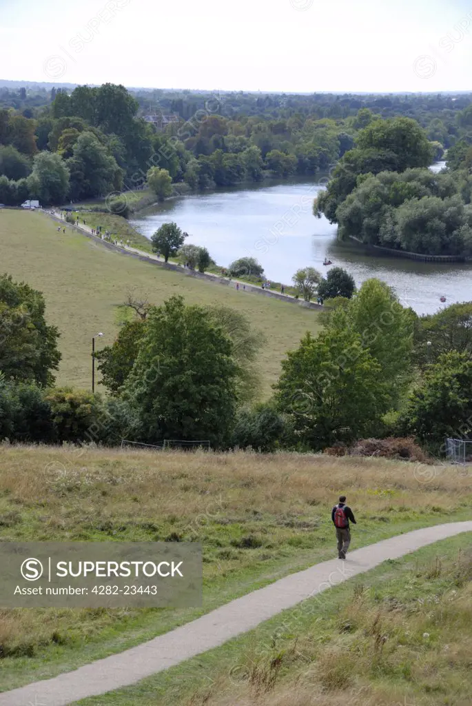 England, London, Richmond-upon-Thames. A man walking down Richmond Hill towards the River Thames.