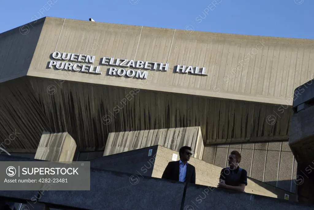 England, London, South Bank. Two men standing outside the Queen Elizabeth Hall which incorporates the Purcell Room, part of the South Bank Centre complex.