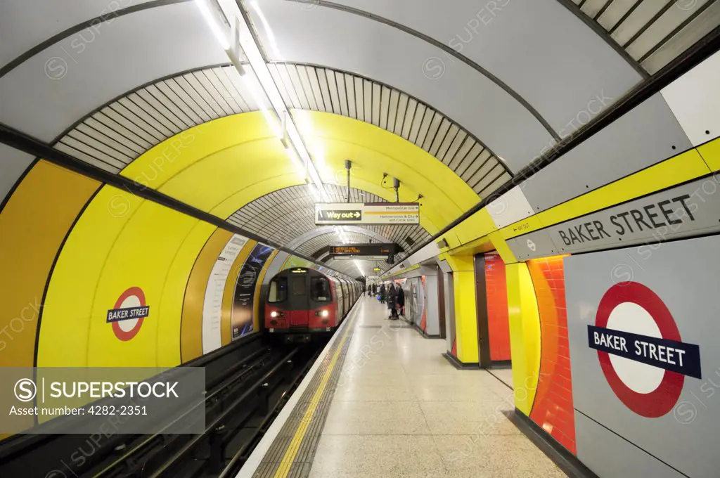 England, London, Baker Street. A tube train on the Jubilee line arriving alongside a platform at Baker Street Underground Station.