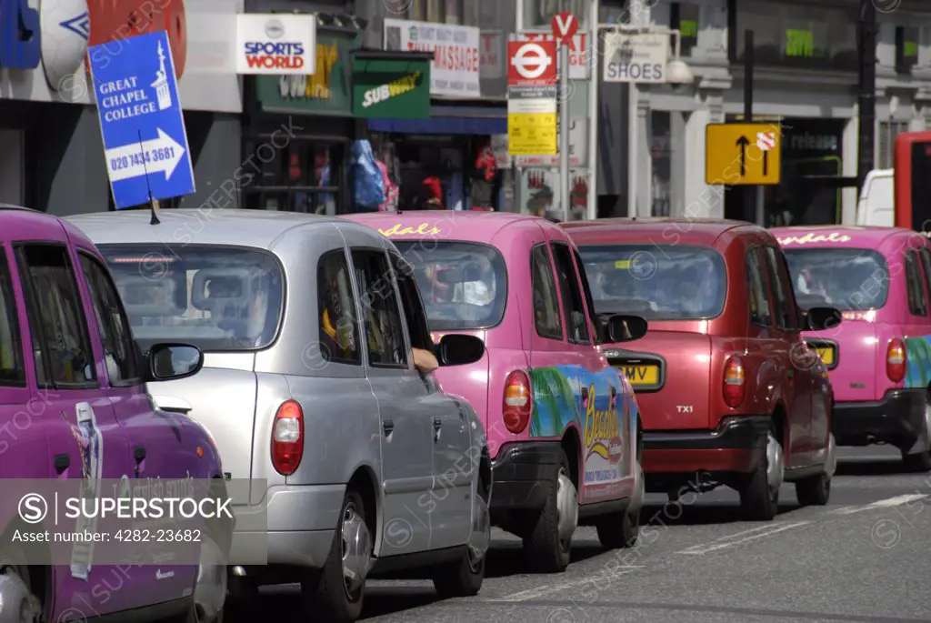 England, London, Oxford Street. A queue of colourful London taxi cabs in Oxford Street.