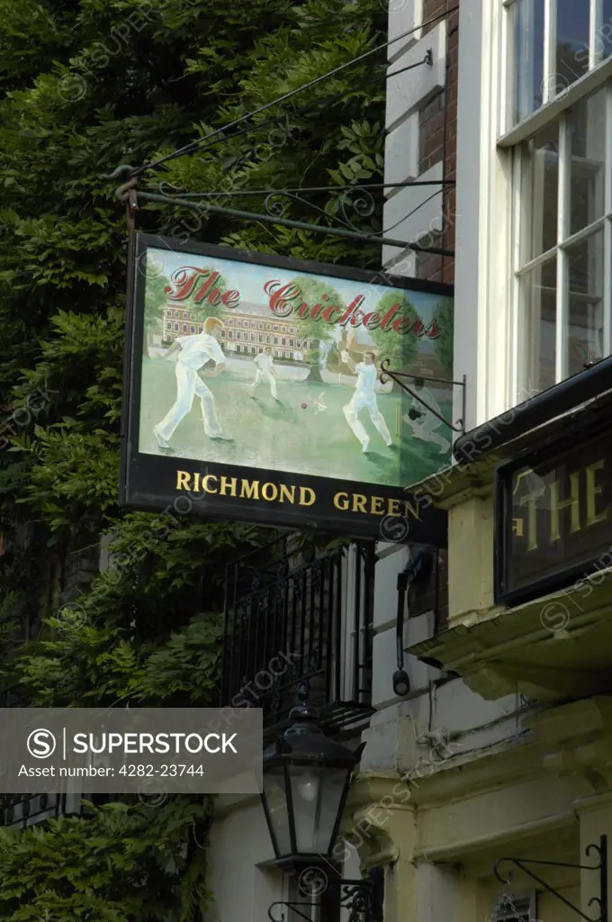 England, London, Richmond Upon Thames. Looking up at the sign for the Cricketers pub next to Richmond Green.