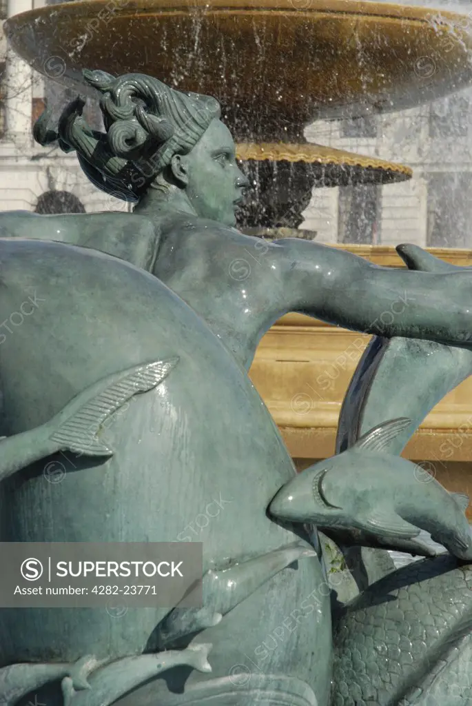 England, London, Trafalgar Square. Close up of mermaid and fish statue in Trafalgar Square fountain.
