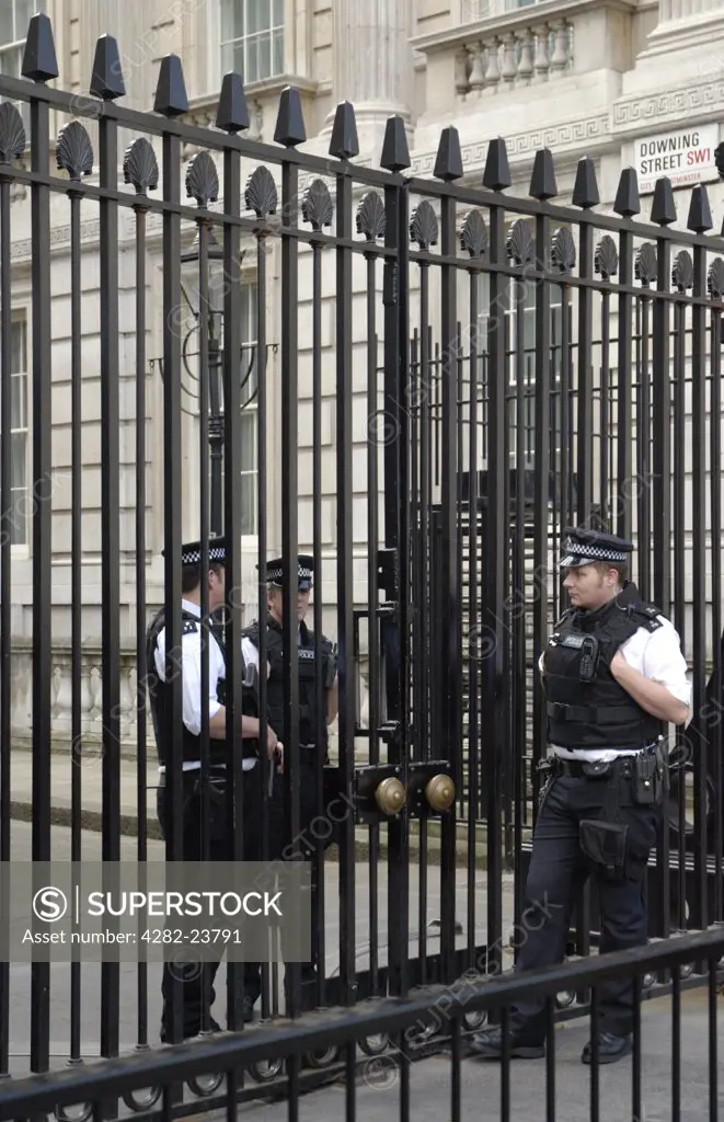 England, London, Downing Street. Policemen guarding the gates of Downing Street.