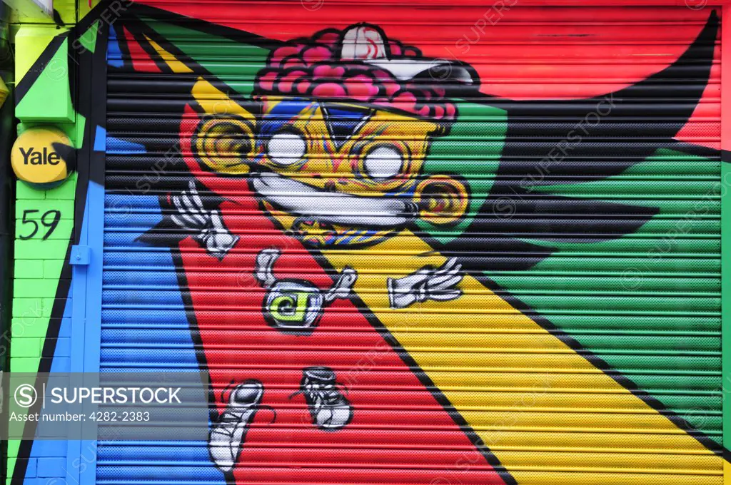 England, London, Brick Lane. Colourful graffiti on the shutter of a shop in Brick Lane.