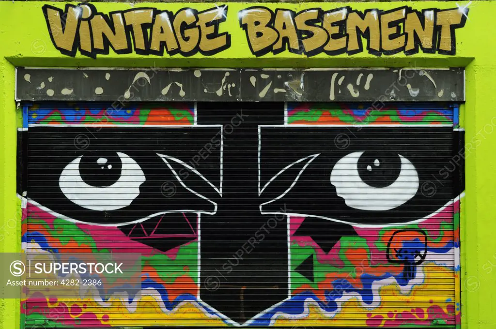England, London, Brick Lane. Graffiti on the shutter of Vintage Basement Shop in Brick Lane.
