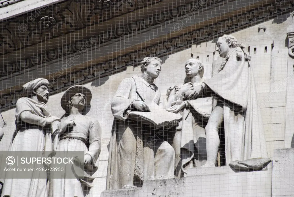 England, London, City of London. A close up of statues on the exterior of the Royal Exchange.