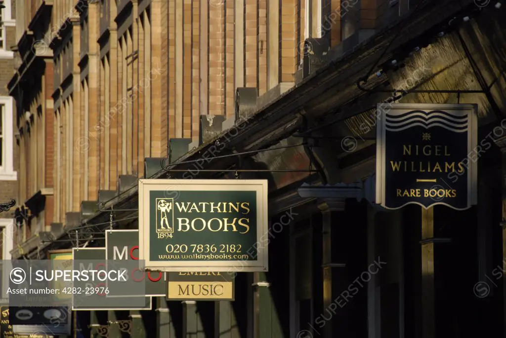 England, London, Westminster. A row of signs for antiquarian bookshops in Cecil Court off Charing Cross Road.