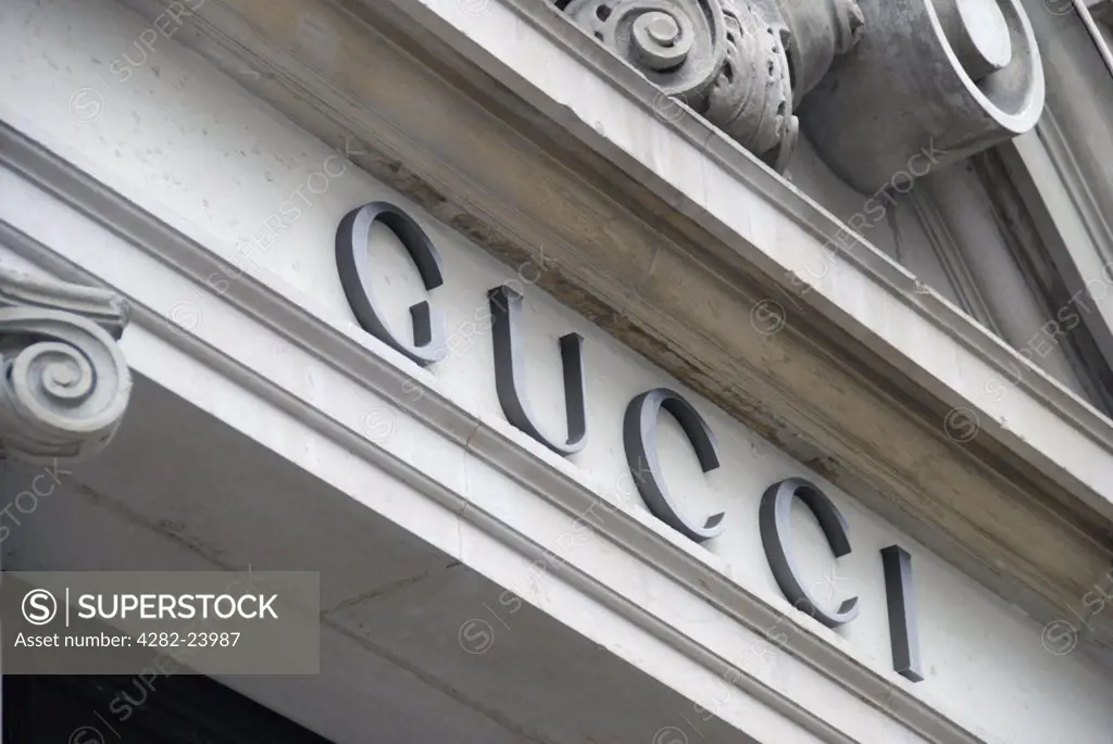 England, London, Bond Street. A close up of the Gucci sign above the shop entrance on Old Bond Street.