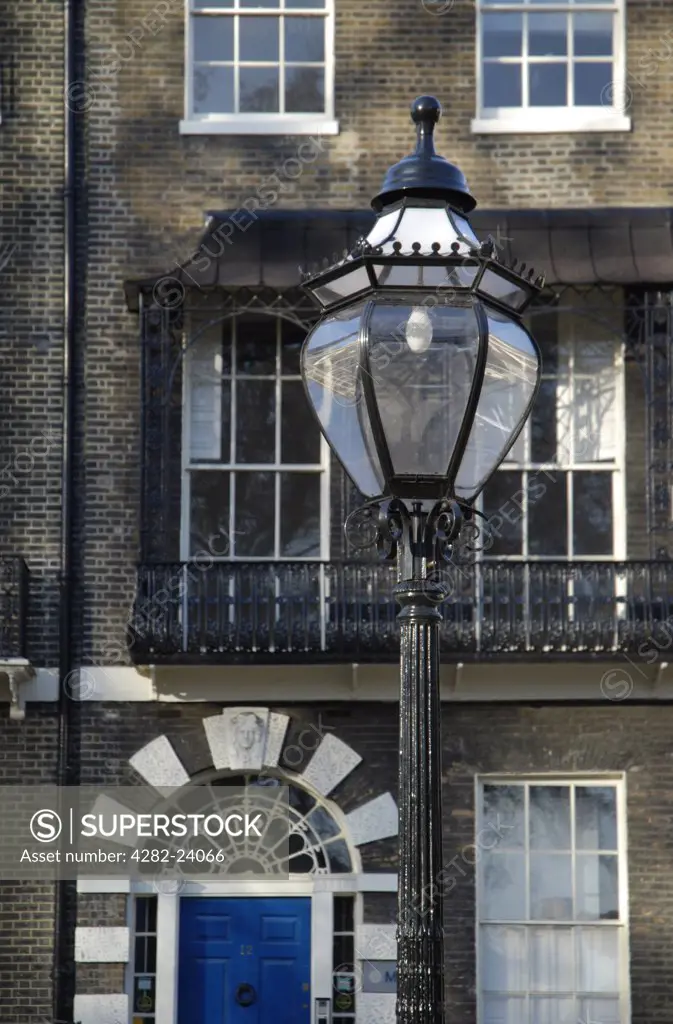 England, London, Bloomsbury. House and old gas lamp in Bedford Square.