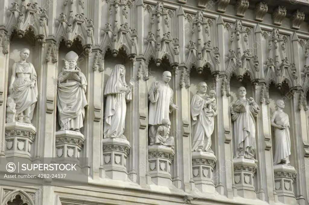 England, London, Westminster. A close up of statues of Christian martyrs above the Great West Door to Westminster Abbey.