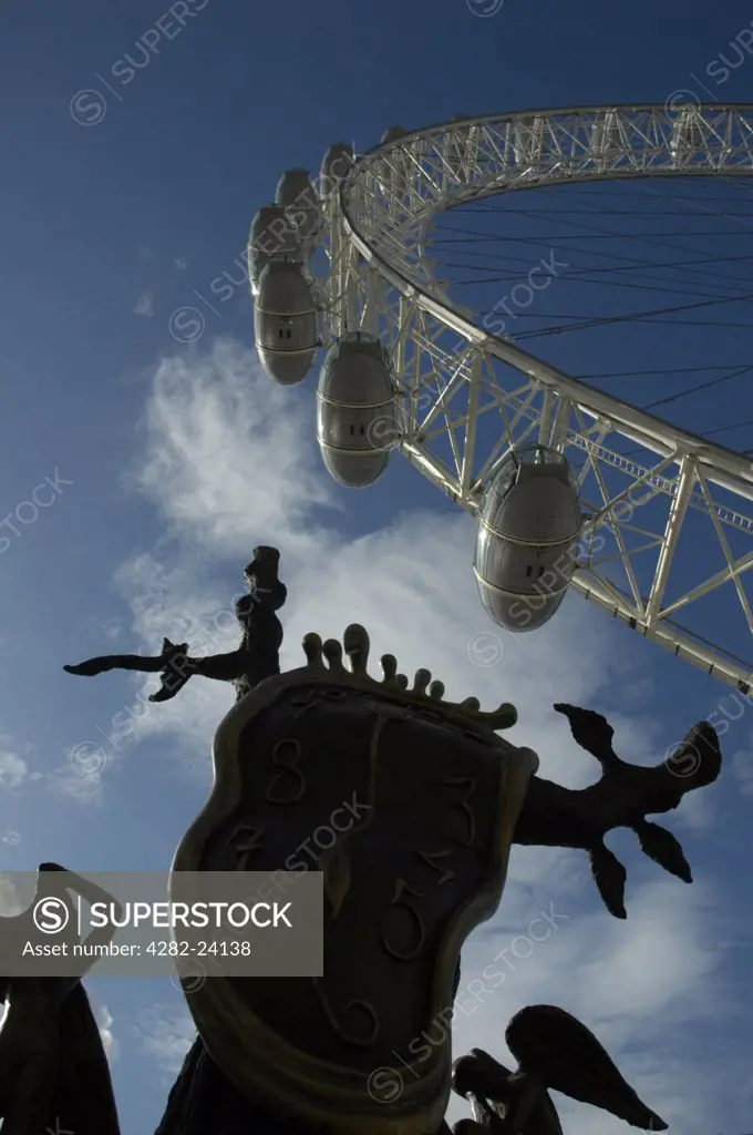 England, London, South Bank. The top of a Dali sculpture and part of the London Eye Ferris wheel.