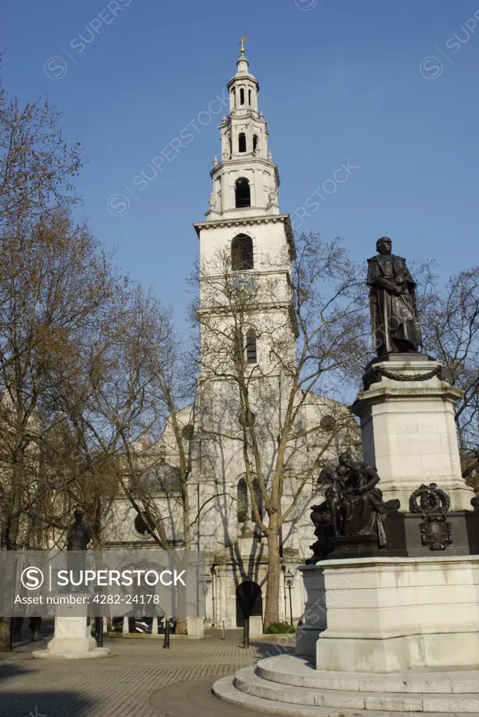 England, London, The City. St Clement Danes church and the statue of William Gladstone in The Strand.