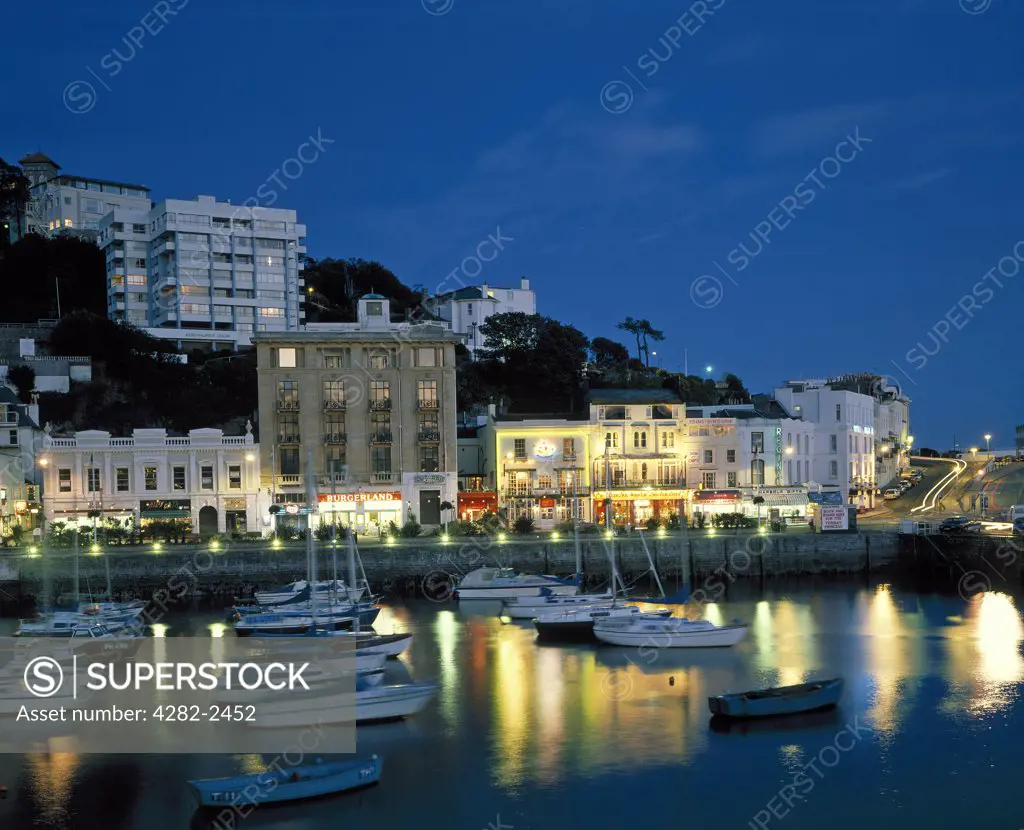 England, Devon, Torquay. View down over the boats in Torquay harbour at night.