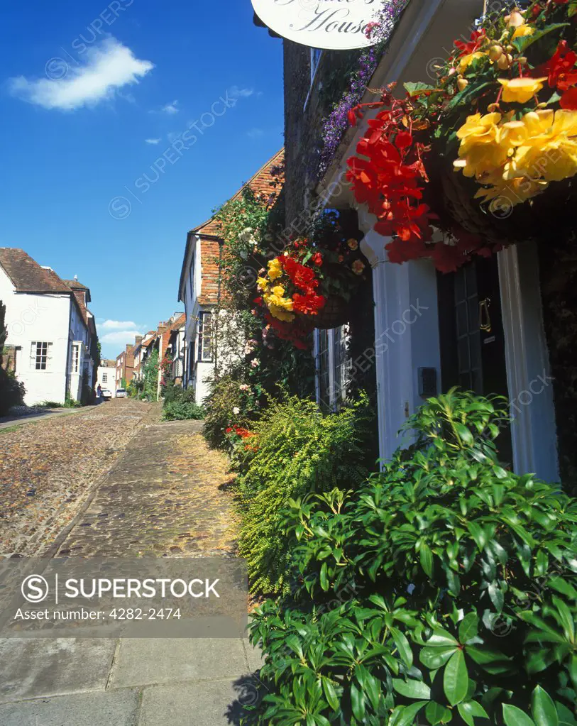 England, East Sussex, Rye. Colourful hanging baskets outside a house on Mermaid Street.