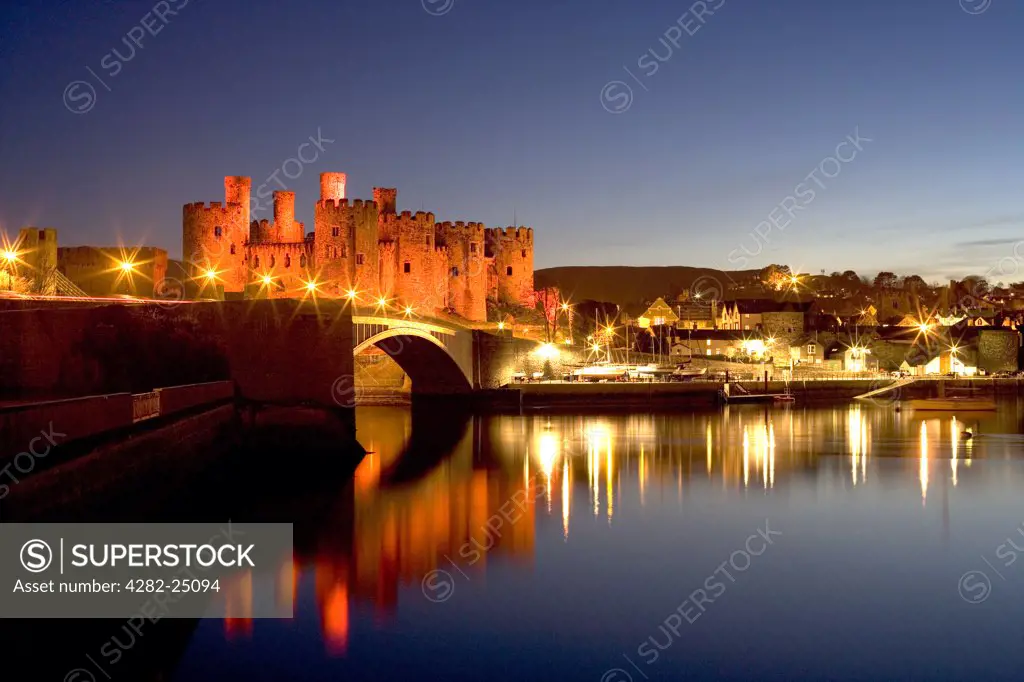 Wales, Clwyd, Conwy Castle. A view of Conwy Castle at dusk from over the River Conwy.