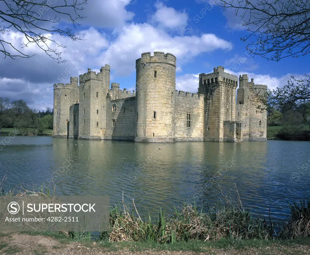 England, East Sussex, Bodiam. A view across the water to Bodiam Castle.