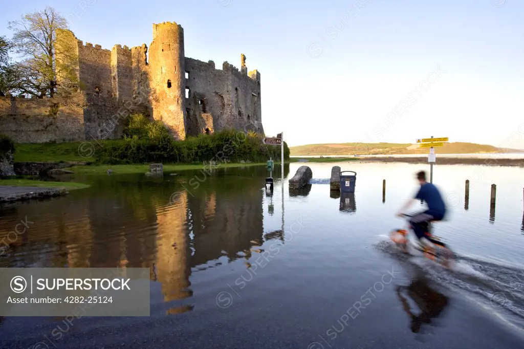 Wales, Carmarthenshire, Laugharne Castle. The river Taf flooding at Laugharne Castle. The castle stands on a low cliff by the side of the Coran stream, overlooking the estuary of the river Taf.
