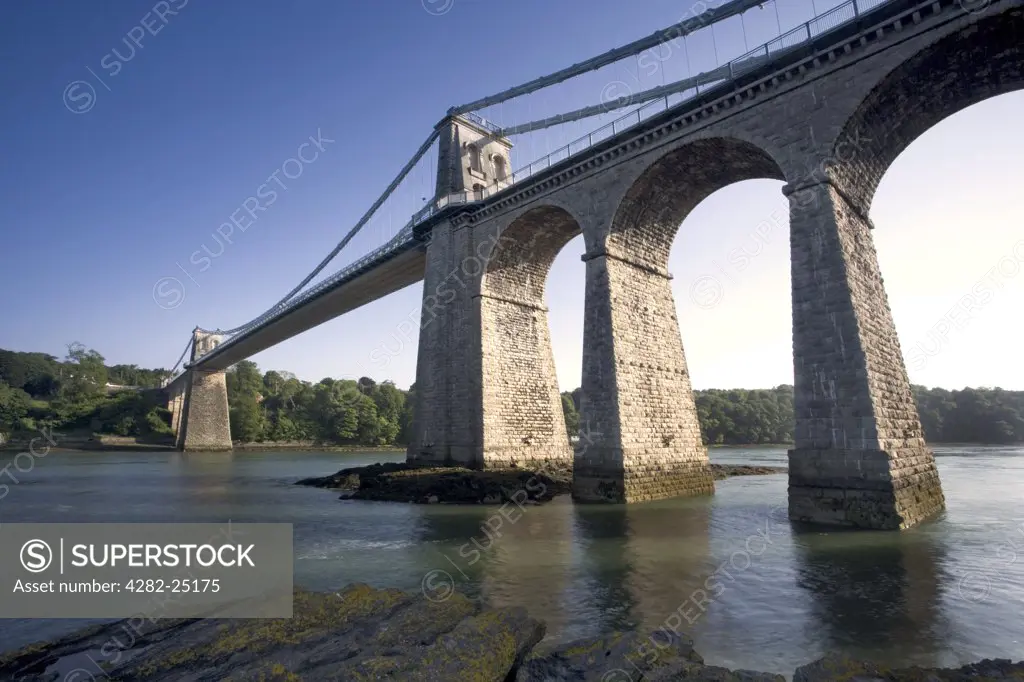 North Wales, Isle of Anglesey, Menai Bridge. The Menai Bridge and the Menai Strait. This was the first iron suspension bridge of its kind in the world, opened on 30th Jan 1826.
