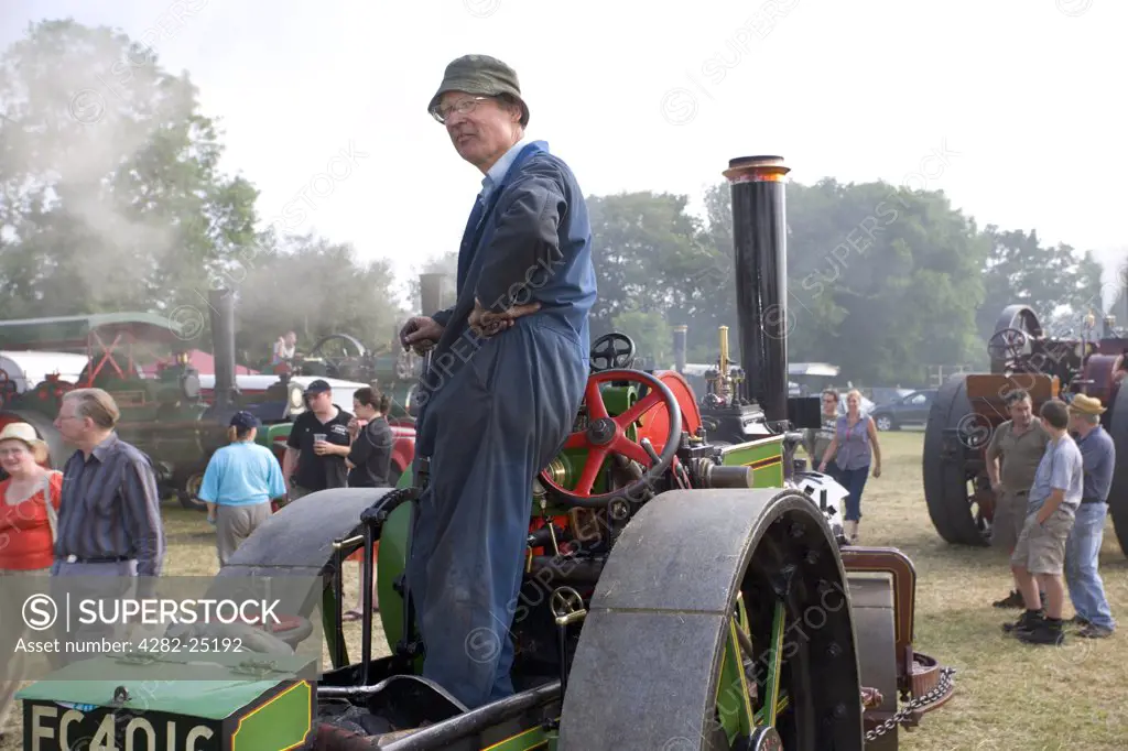 England, Hertfordshire, Whitwell. Driver and a four ton Aveling & Porter road roller at the Whitwell Steam and Country Fair.