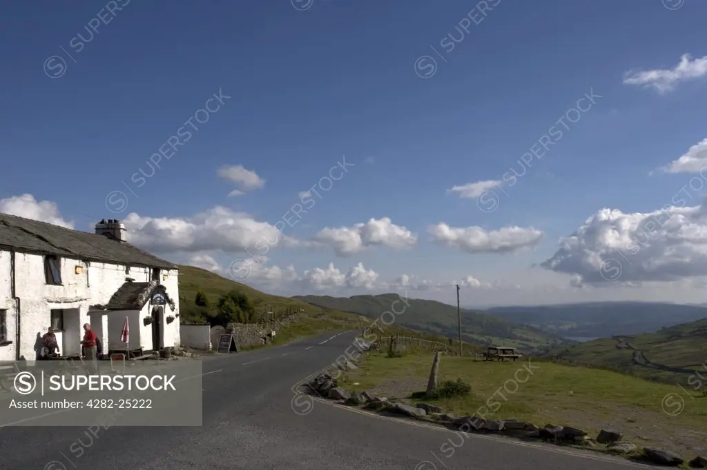 England, Cumbria, Kirkstone. Exterior view of the The Kirkstone Pass Inn and surrounding hills. It has been  serving travellers from at least the mid  19th Century although the earliest records for the existing building date from 1496AD.