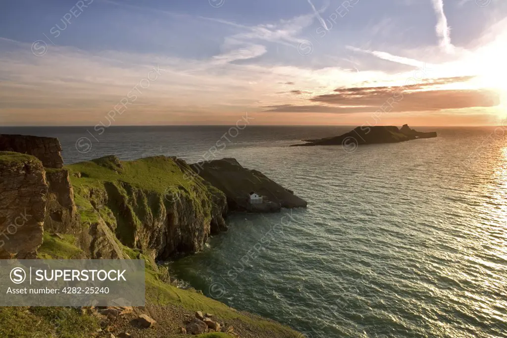Wales, Swansea, Rhossili Bay. A view toward Worms Head and the Kitchen Corner boat house in Rhossili Bay.