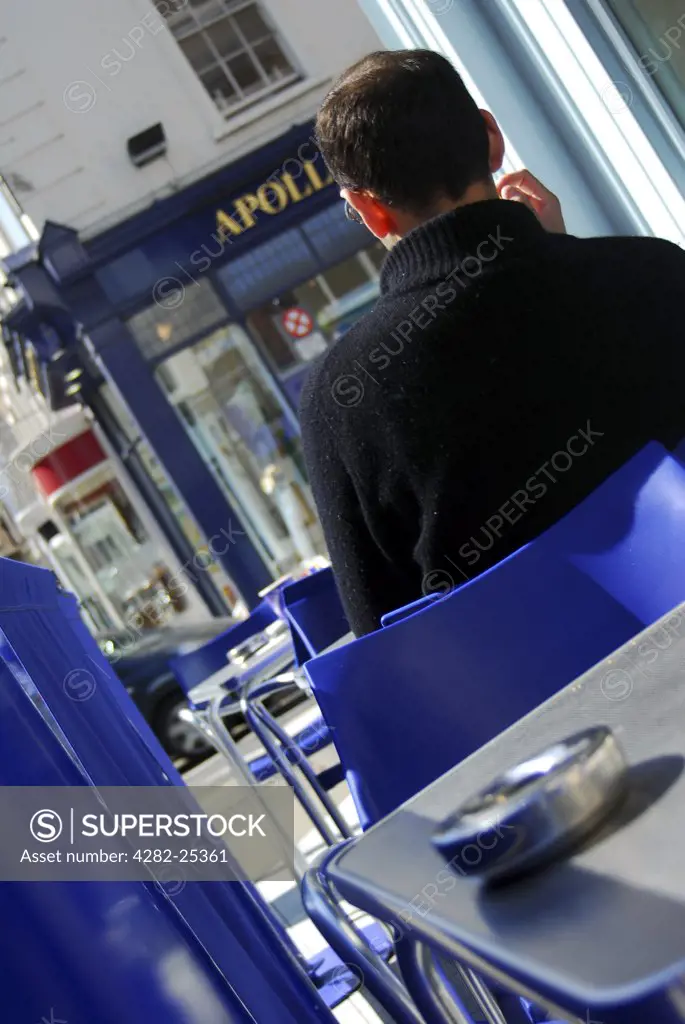 Republic of Ireland, Dublin, Dawson Street. A man sitting at a cafe in Dublin's Dawson Street.