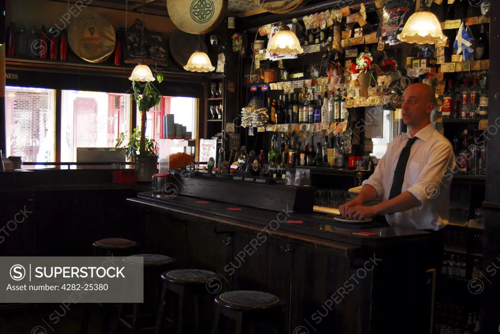 Republic of Ireland, Dublin, Merrion Row. The bar and barman at Foley's Restaurant in Dublin.